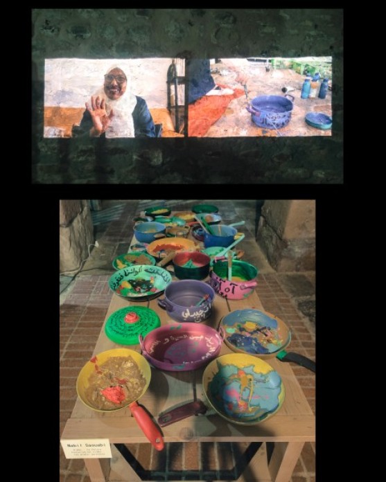 Two images together, the one on the top is a still image of a video projection on a wall, with a woman in a hijab waving on the left and a woman stirring a pot on the right. The bottom image is many colorful pots arranged on the top of a table.