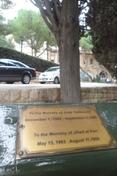 Image of a bench at the American University of Beirut with two dedications to two former young AUB students who were killed during the war