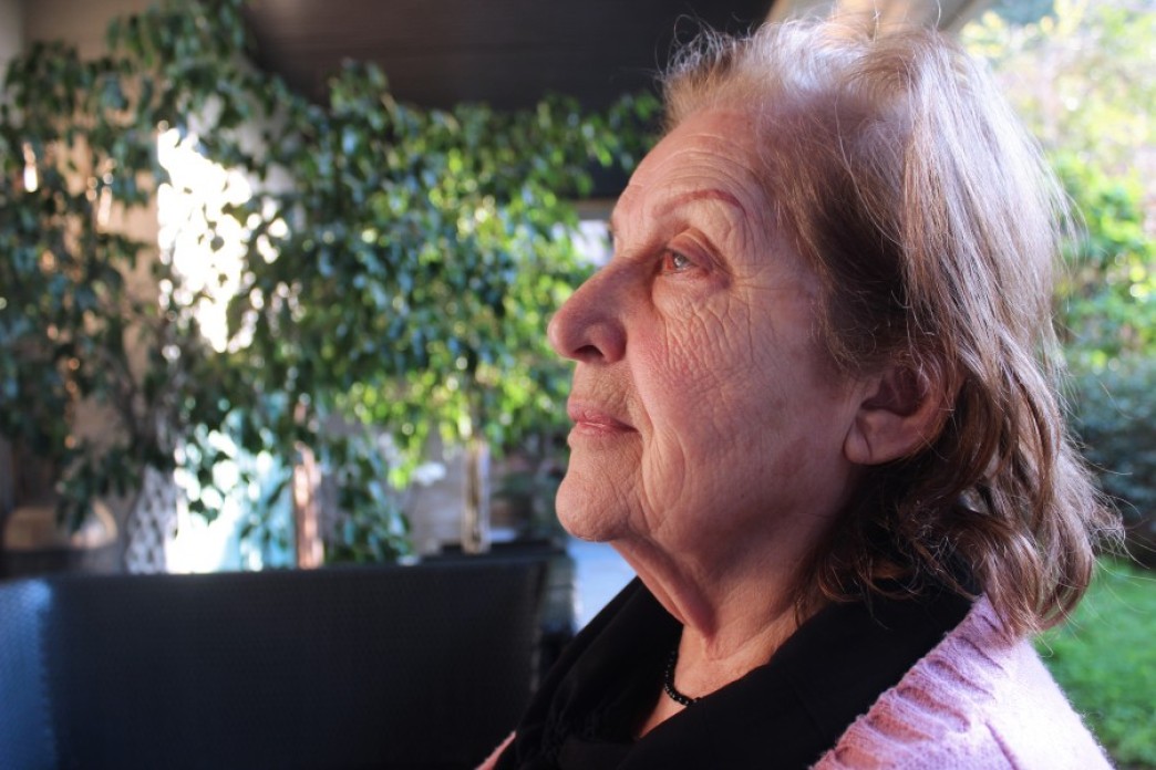 Image of a grandmother with the wrinkles left on her face that are the result of the death of her husband during the war