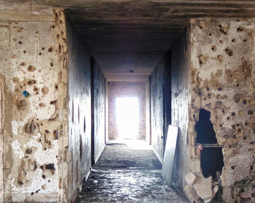 Image of an old destructed hotel in Lebanon with bullet scars