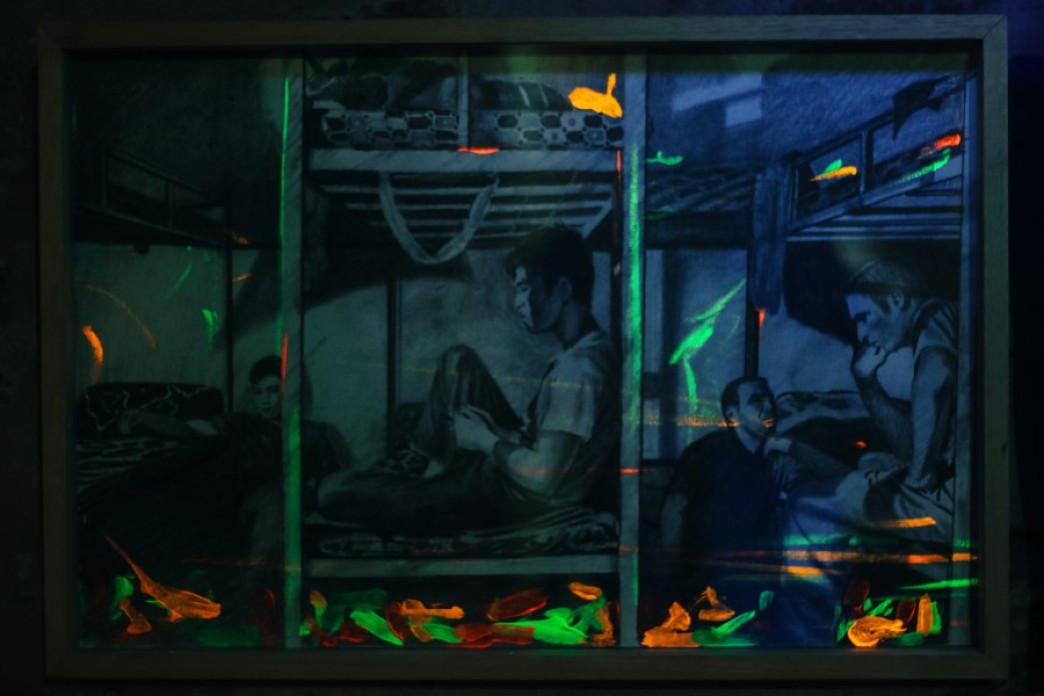 A drawing of men in a room, sitting on bunkbeds close together like in a prison, with some fluorescent paint, shown under a black light.